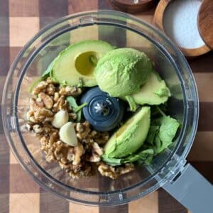 Avocado Pesto ingredients in the bowl of a food processor