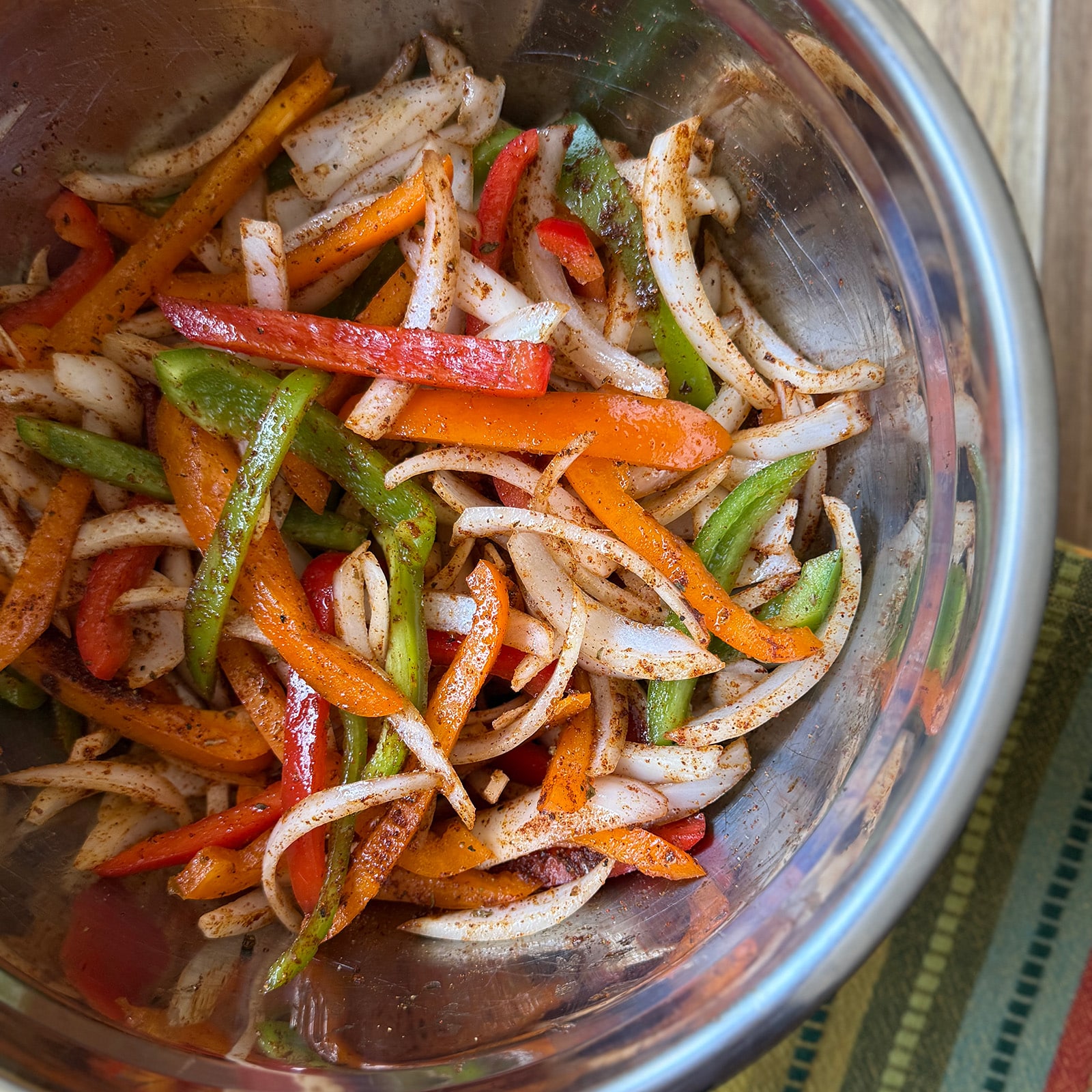 Peppers and Onions in a Bowl with Seasoning