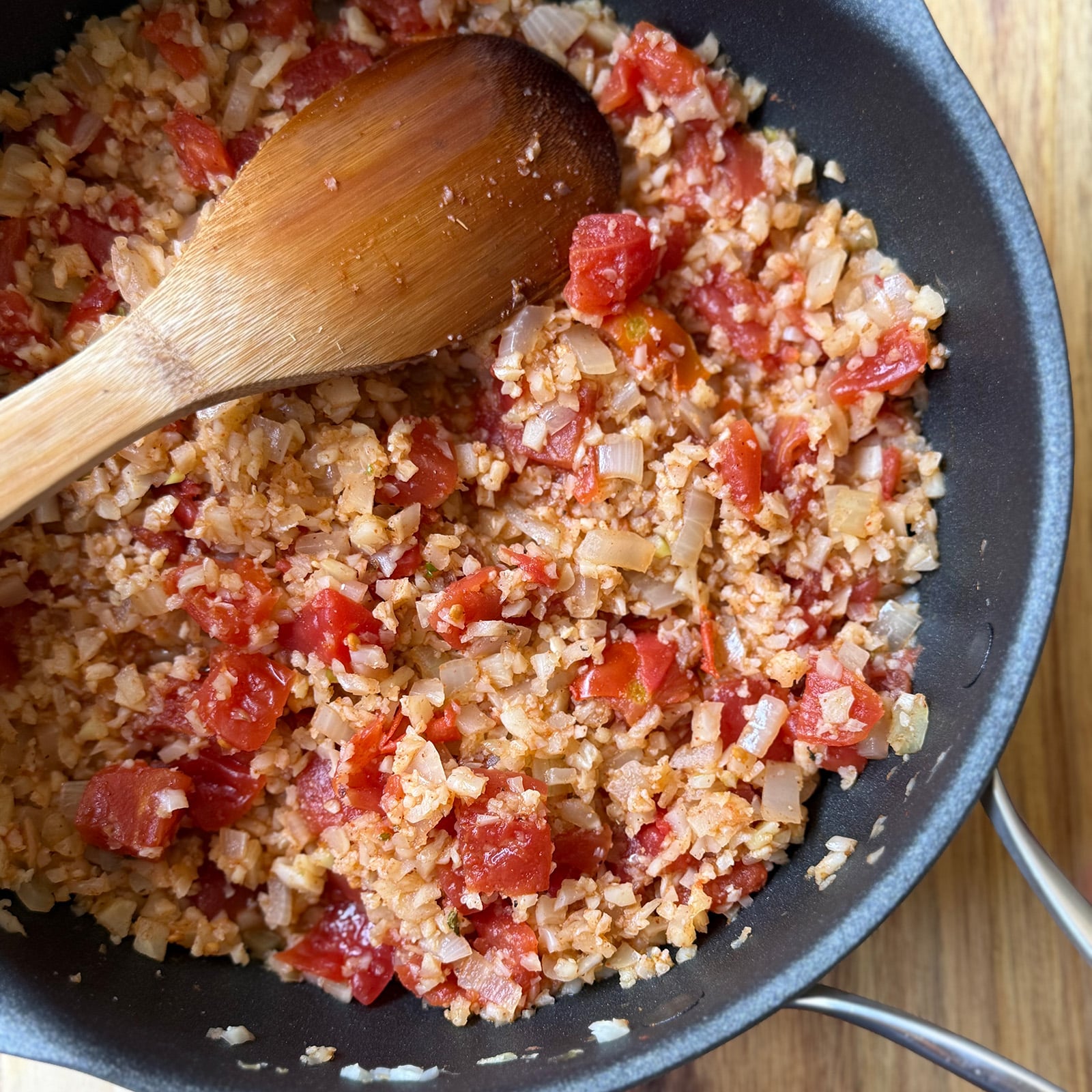 Once the diced tomatoes and fajita spice are stirred in, the mixture cooks down until the liquid mostly evaporates and soaks into the rice.