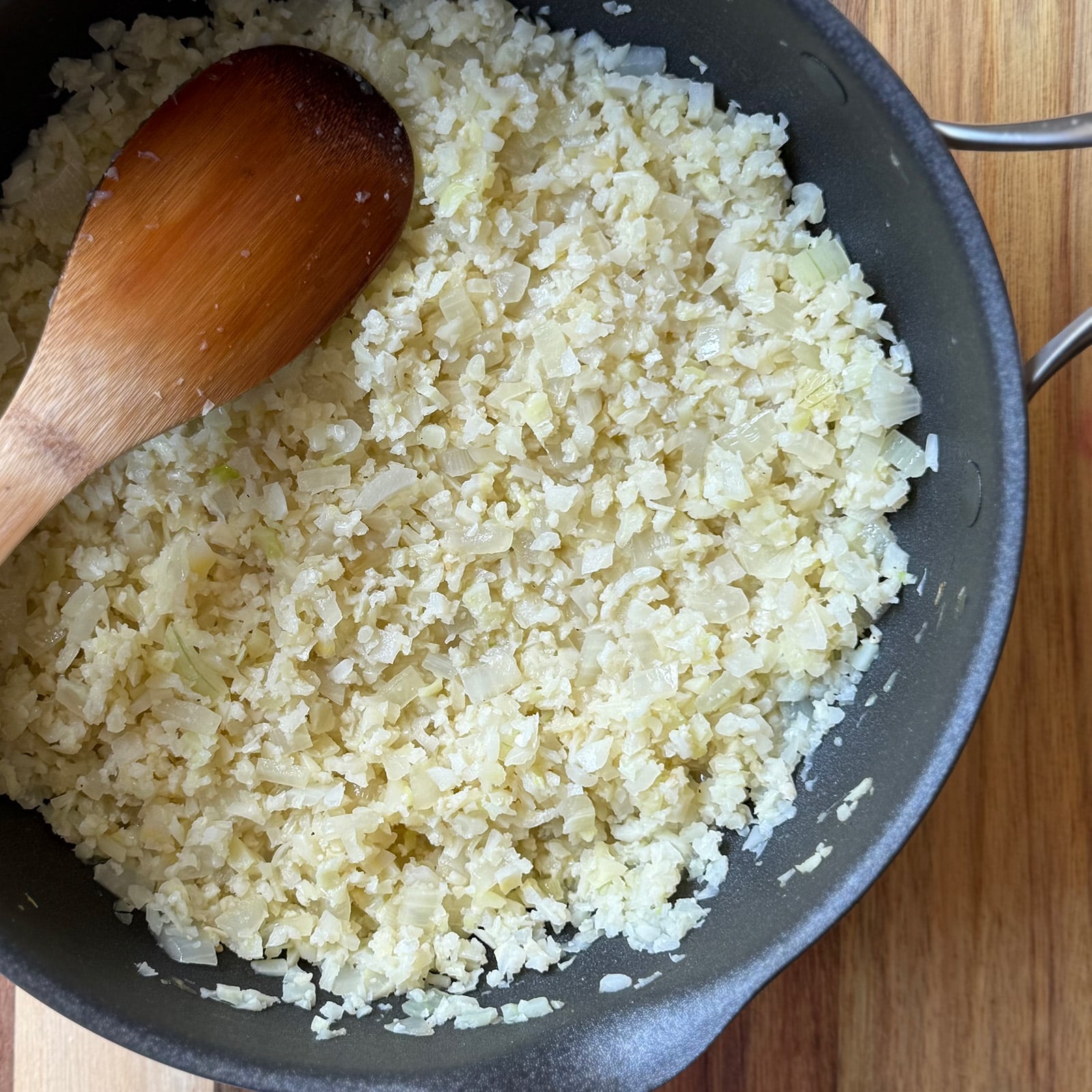 The cauliflower and onion cook down together first, giving the cauliflower a chance to release its moisture before anything else goes in.
