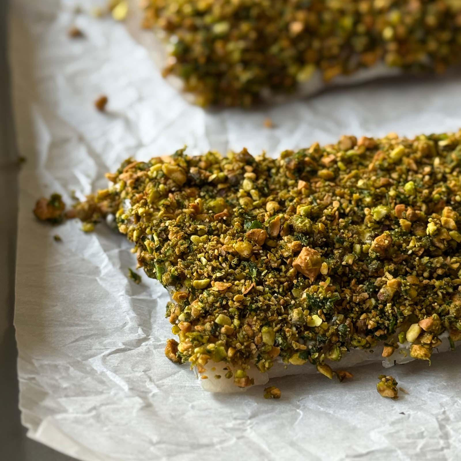 Fish crusted with pistachios before baking