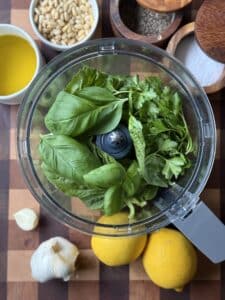 Ingredients for Dairy Free Pesto in the bowl of a food processor