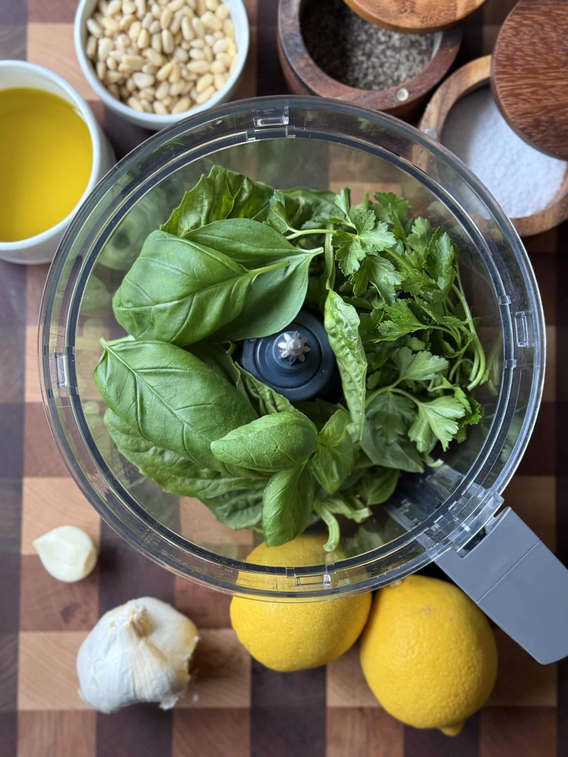 Ingredients for Dairy Free Pesto in the bowl of a food processor