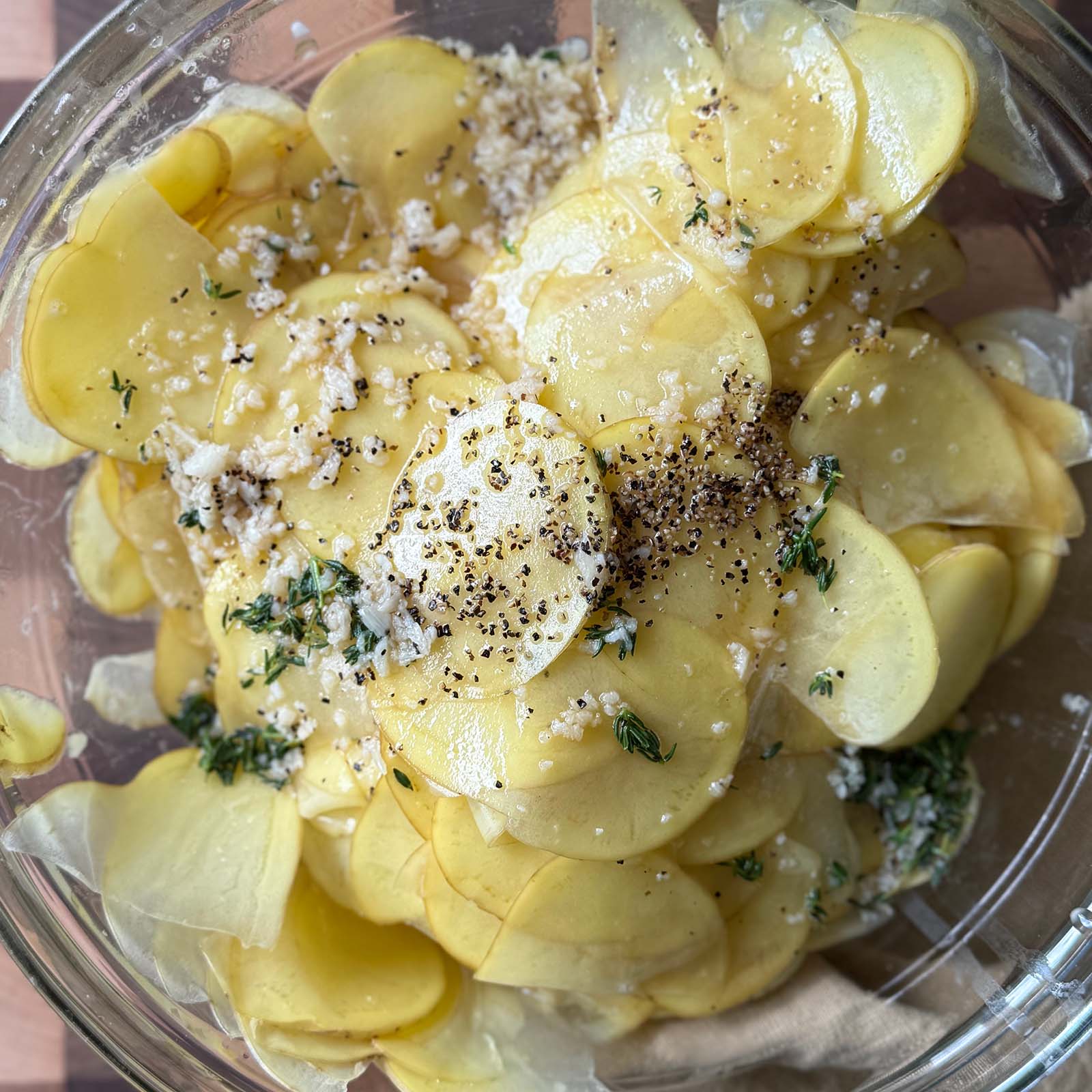 Butter Broth Combined in Bowl with Sliced Potatoes
