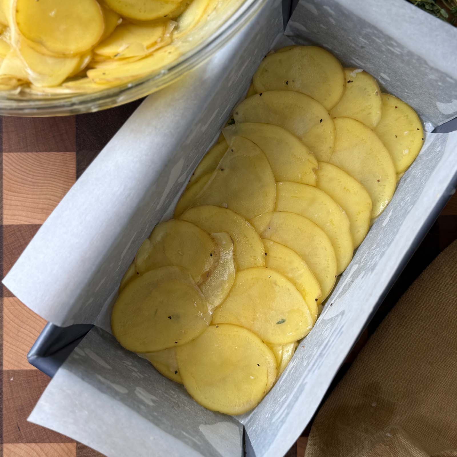 First Layers of Potatoes in a Parchment Lined Pan