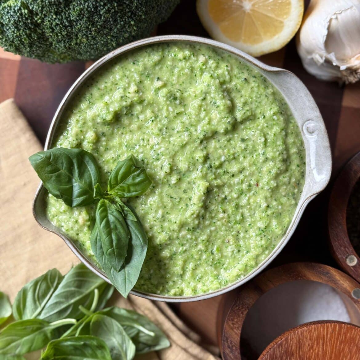 Broccoli Pesto in a bowl with basil leaves as a garnish