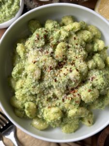 Broccoli Pesto and Gnocchi in a white bowl.