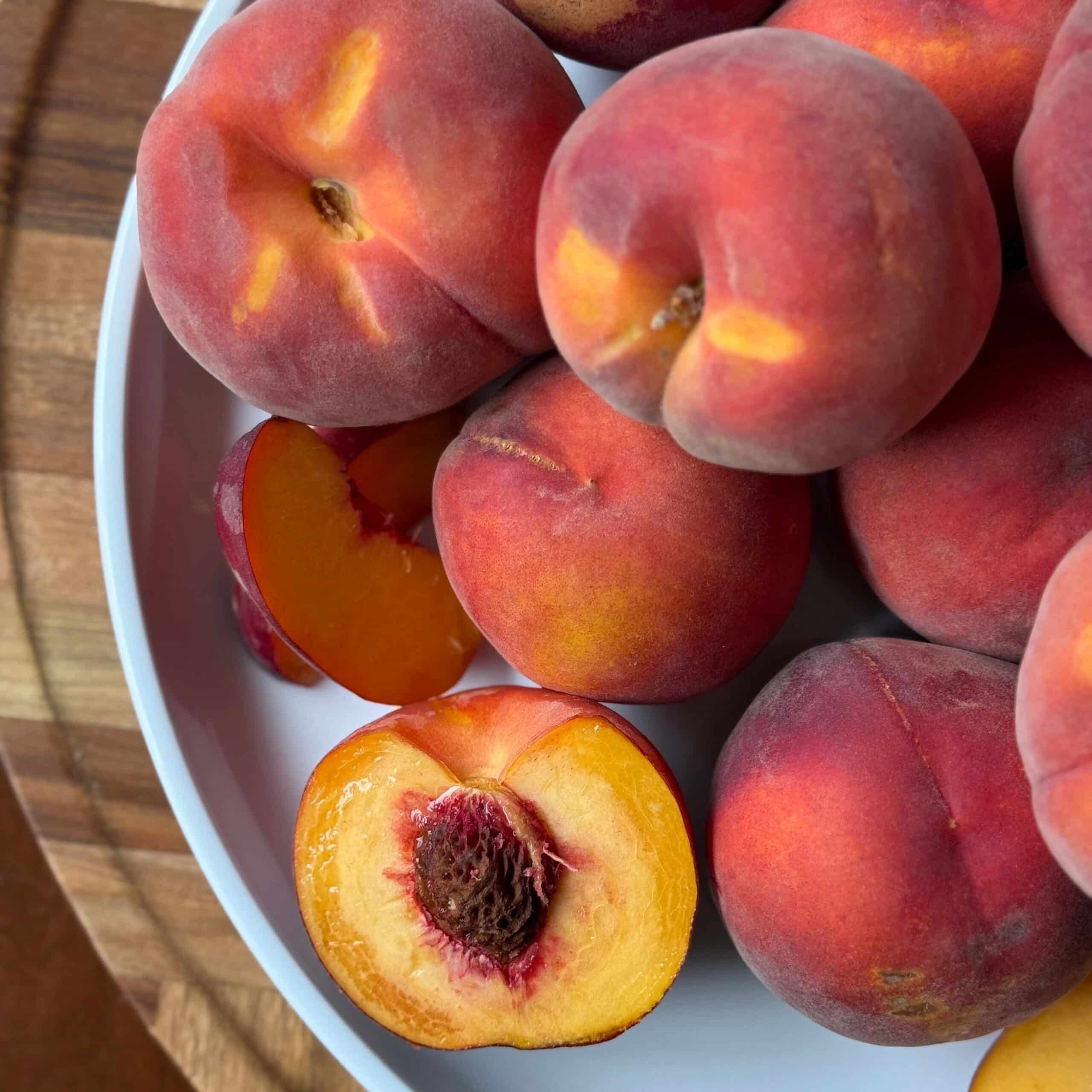 Fresh ripe peaches in a bowl for burrata peach salad
