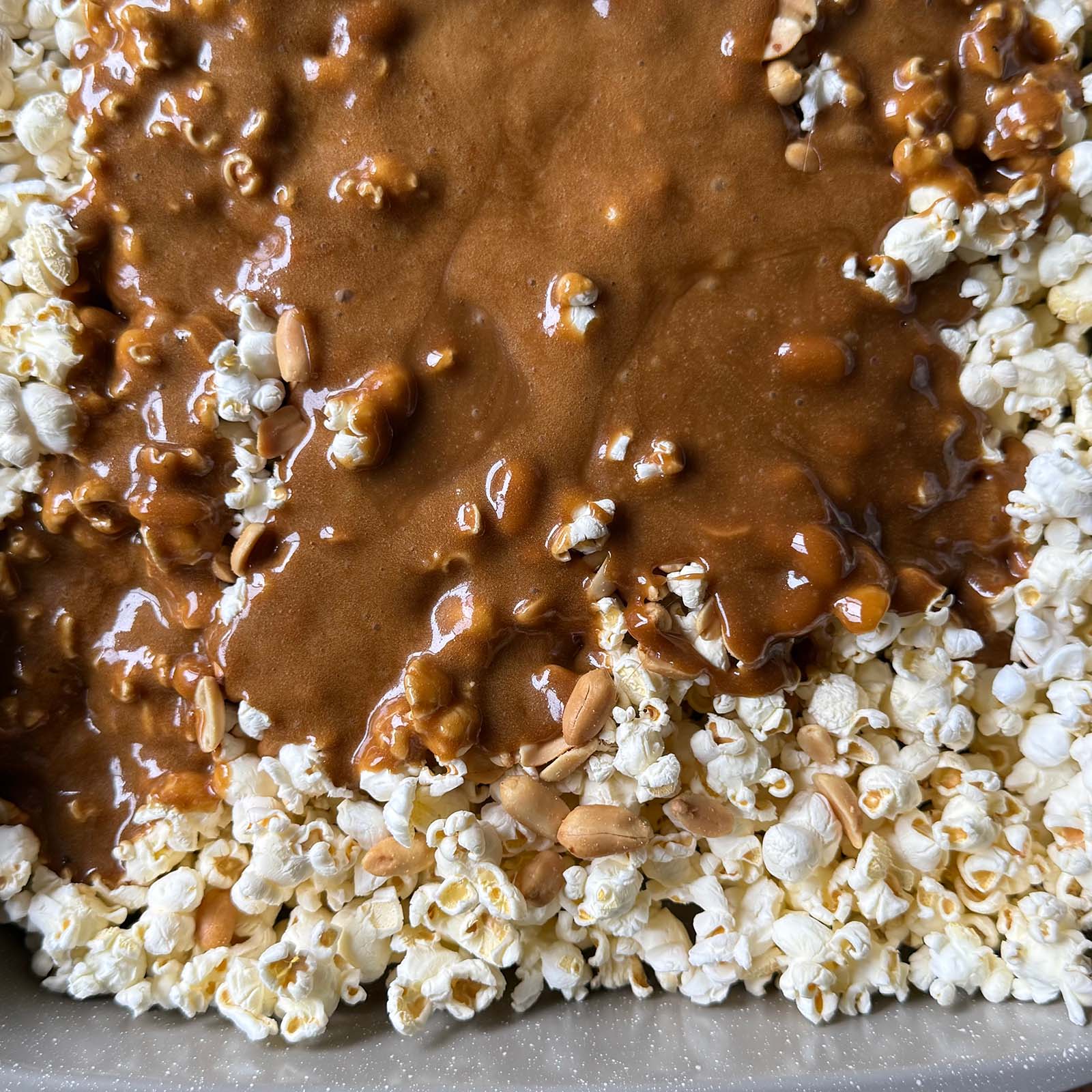 Caramel Sauce Poured onto Popcorn and Peanuts