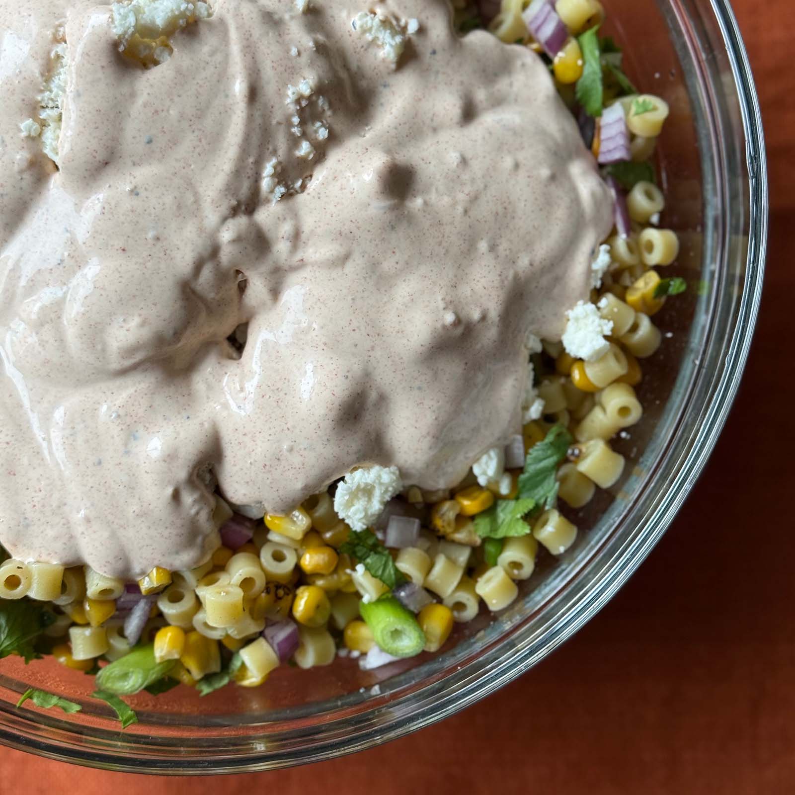 Dressing and Cotija Cheese in Mexican Street Corn Pasta Salad