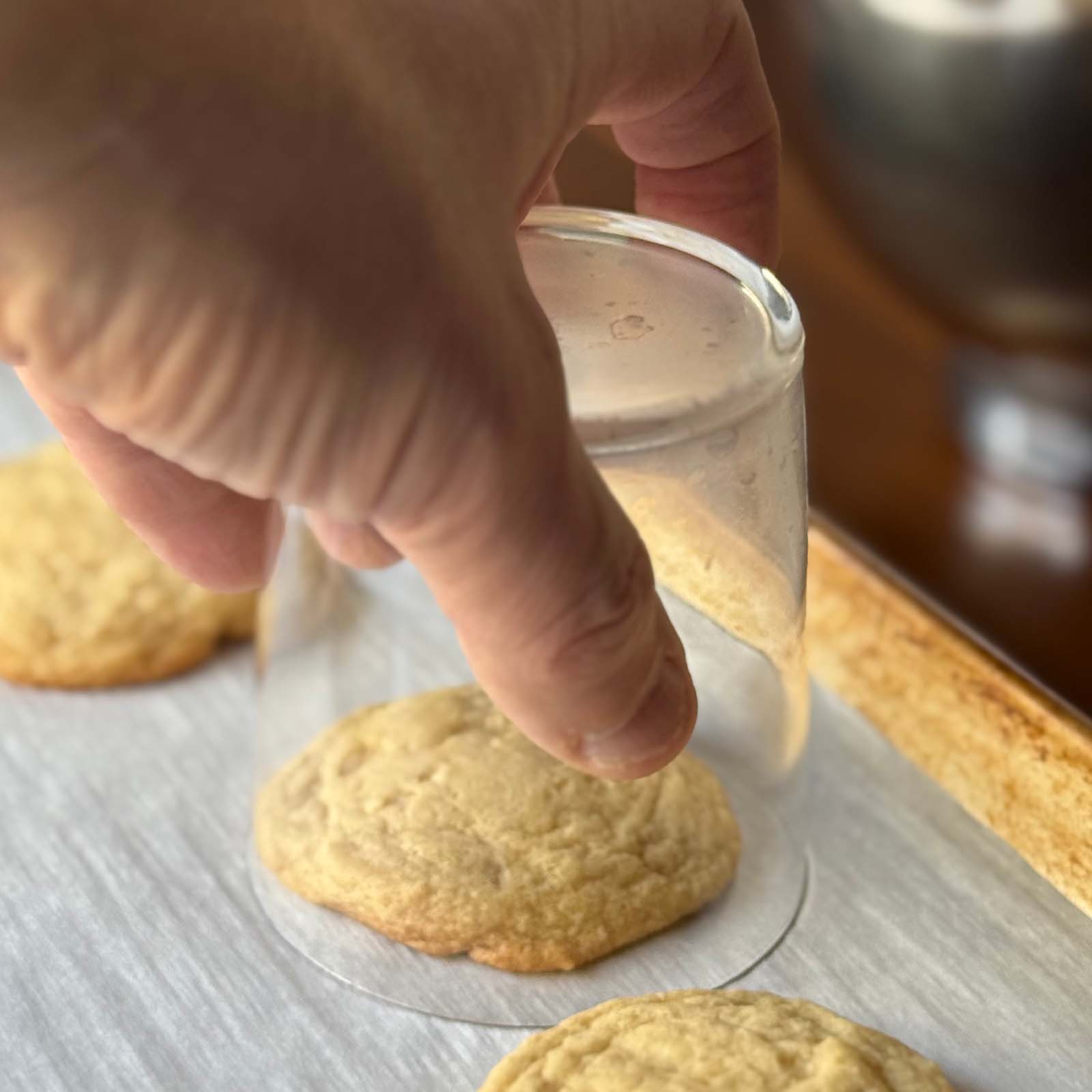 Hand on Glass Covering a Warm Cookie to Shape Perfectly