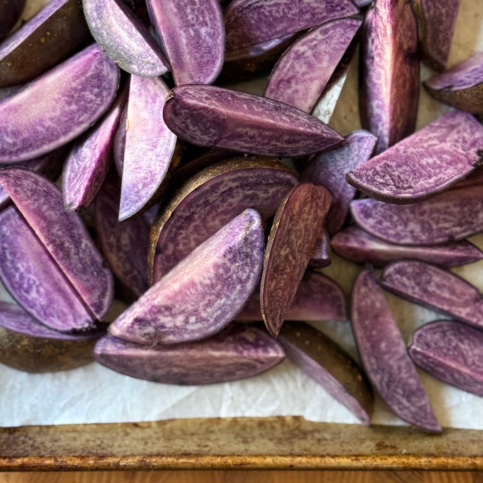 Raw Purple Potato Wedges on a Sheetpan